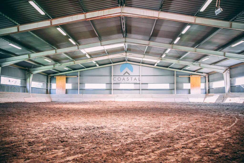 Covered riding arena inside a steel horse barn
