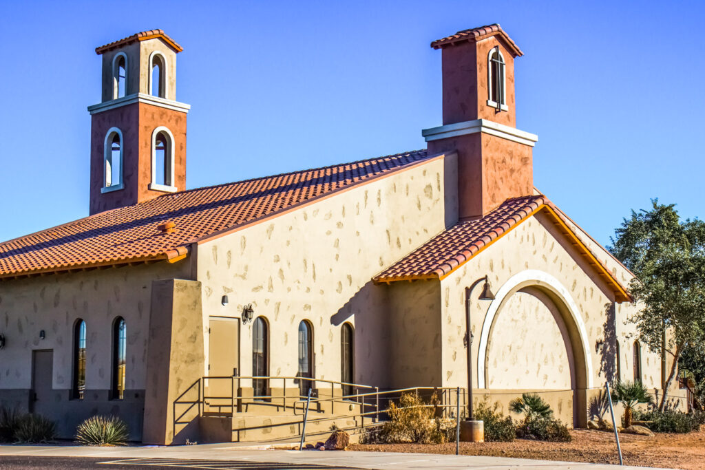 Mediterranean-style steel church building with twin bell towers