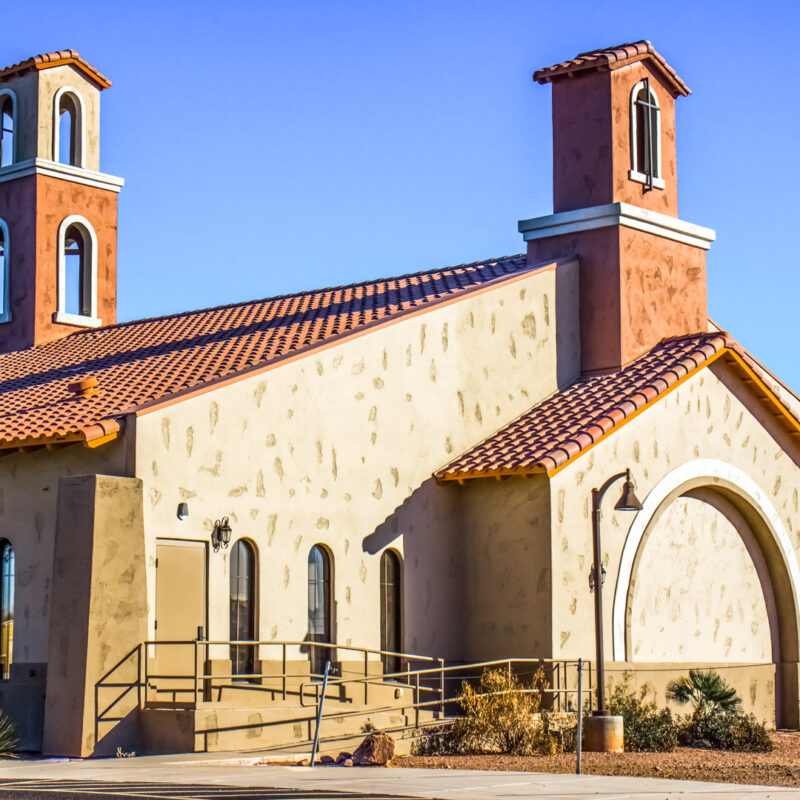 Mediterranean-style steel church building with twin bell towers