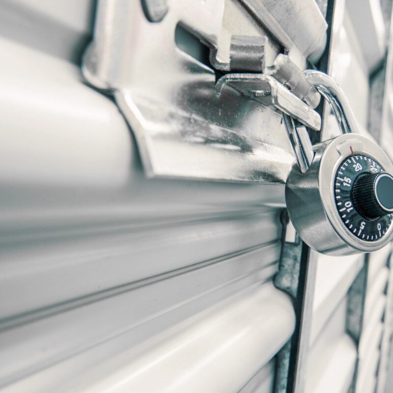 Close-up of steel storage unit door with combination lock