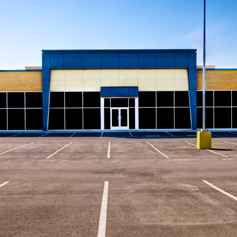 Modern commercial metal building with empty parking lot