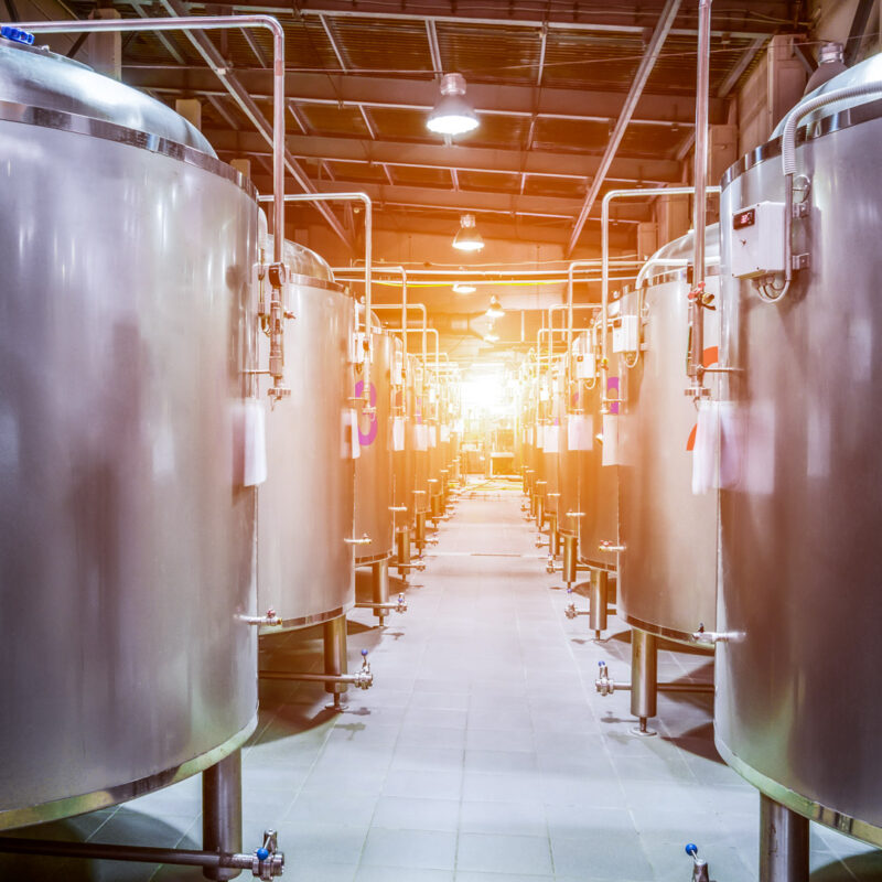 Stainless steel tanks inside a metal building facility