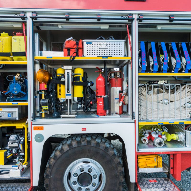 Fire truck equipment storage compartments with hoses and gear