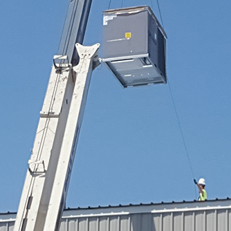 A Man Taking AC on the Roof of Meta Building With Crane