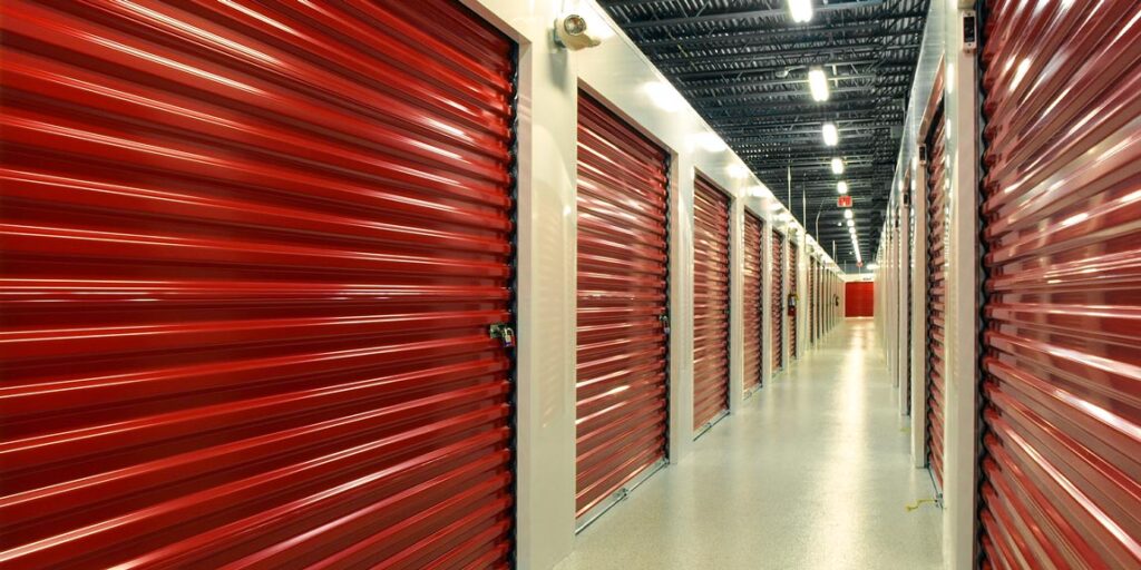 Interior corridor of commercial metal storage building with red unit doors