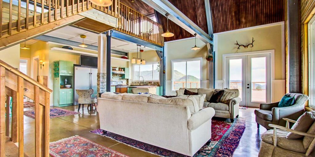 Spacious metal building living room with loft and kitchen