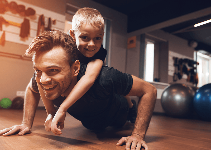 Father and son exercising in gym studio run image