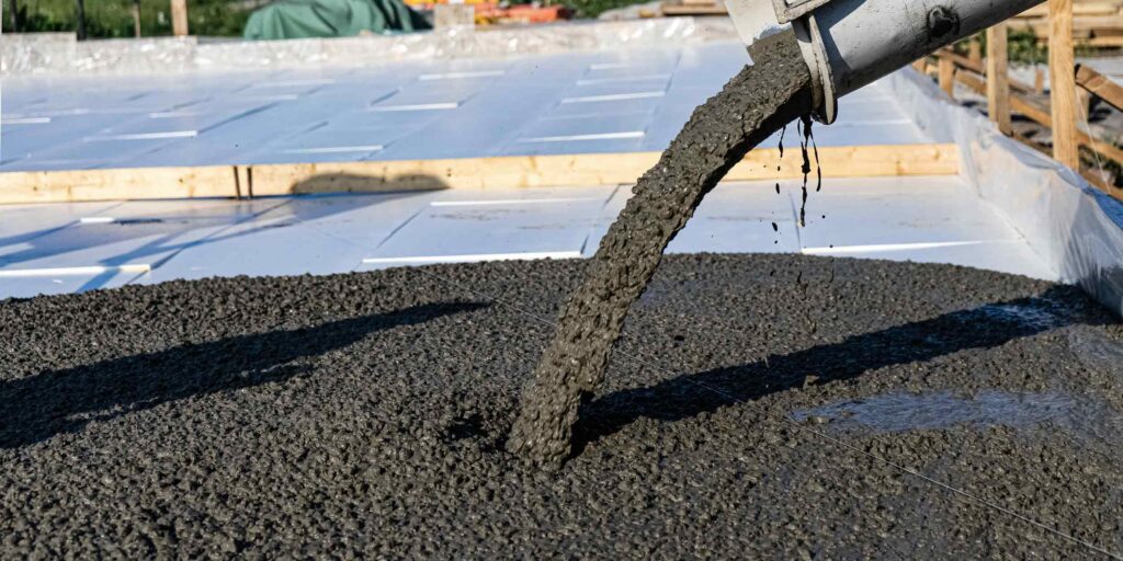Concrete being poured for a steel building foundation