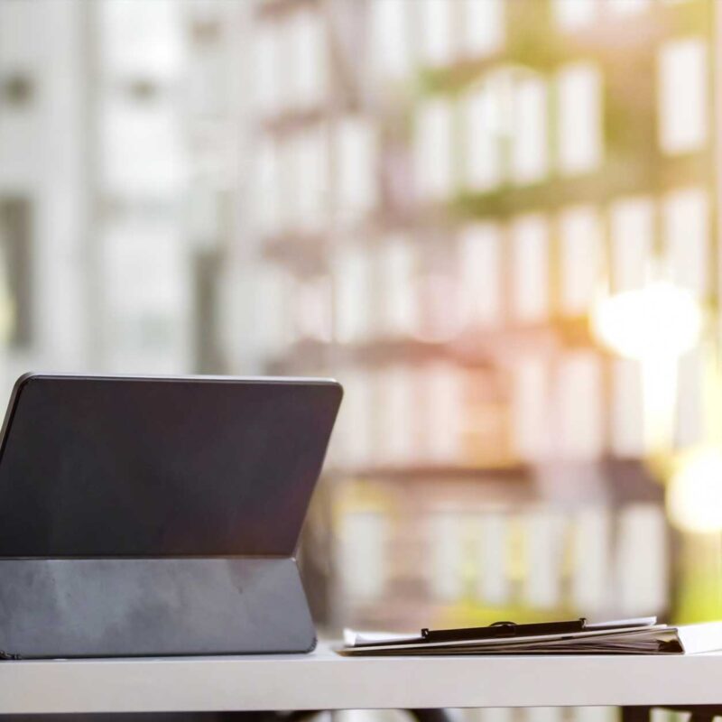 Modern office desk with laptop and plant in metal building interior