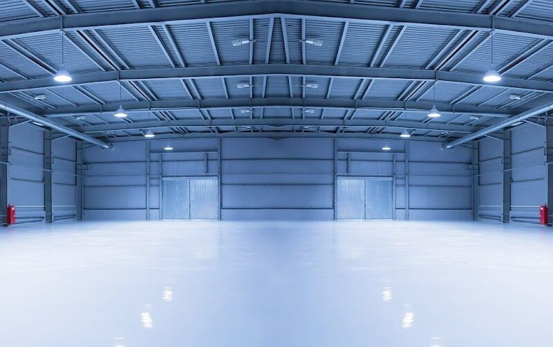 Interior of a steel aircraft hangar with open floor space