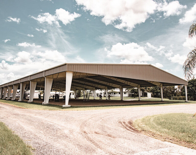 Covered riding arena with steel building structure