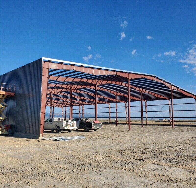 Steel horse barn with covered riding arena under construction
