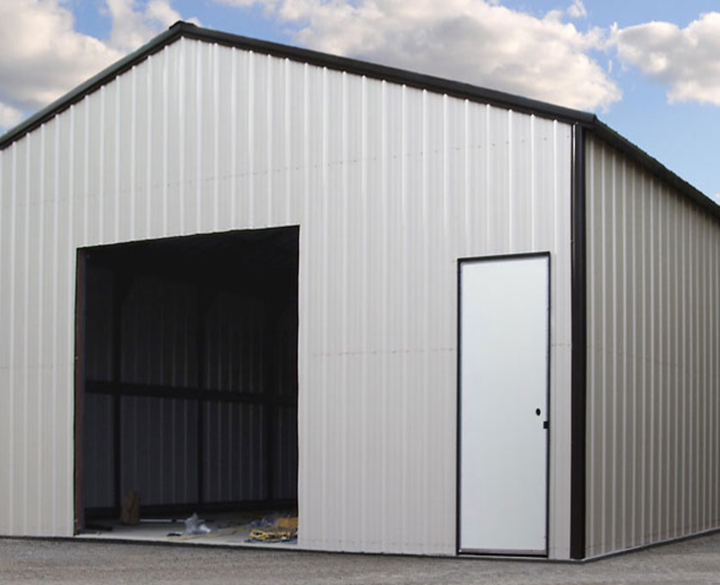 Pre engineered metal building with large garage opening