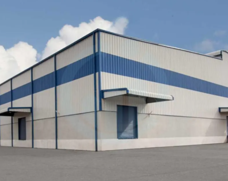 Commercial metal building with blue accents and loading docks