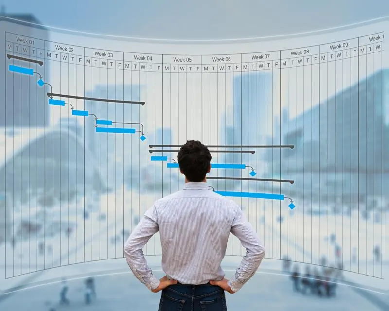 Professional viewing construction project timeline on transparent display
