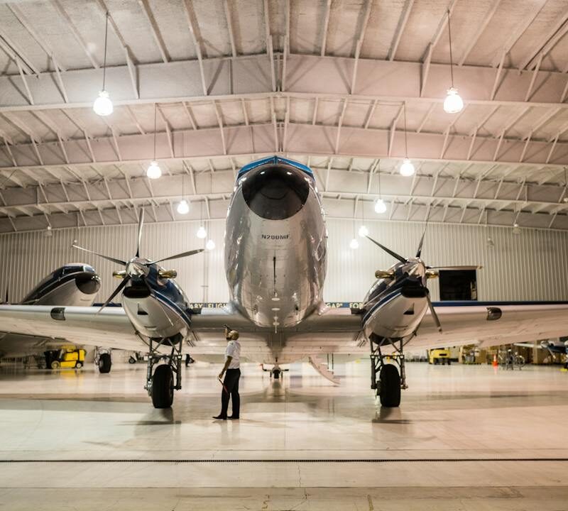 Aircraft hangar with twin-engine plane inside steel building