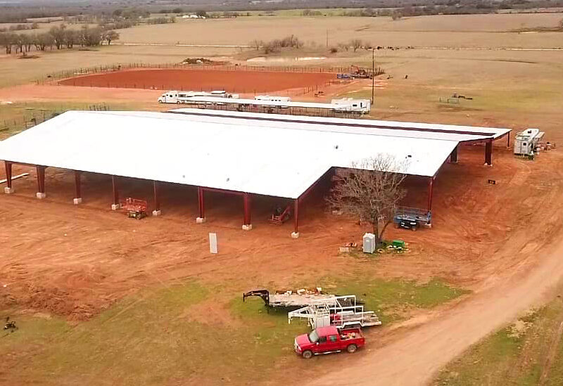 Covered riding arena with steel structure on rural property