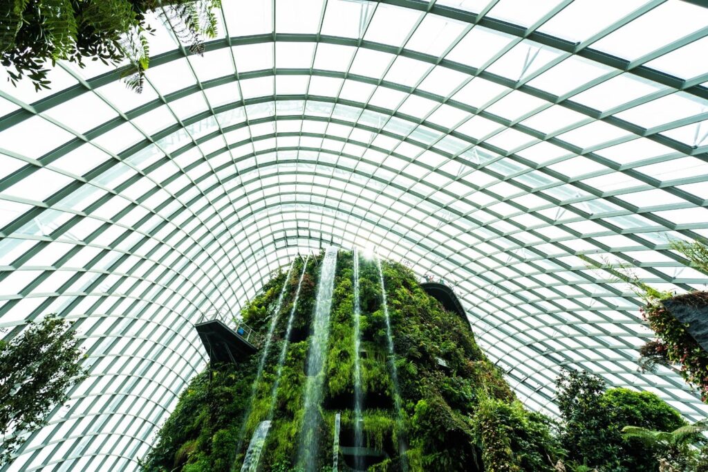 Glass-domed metal building with indoor waterfall garden