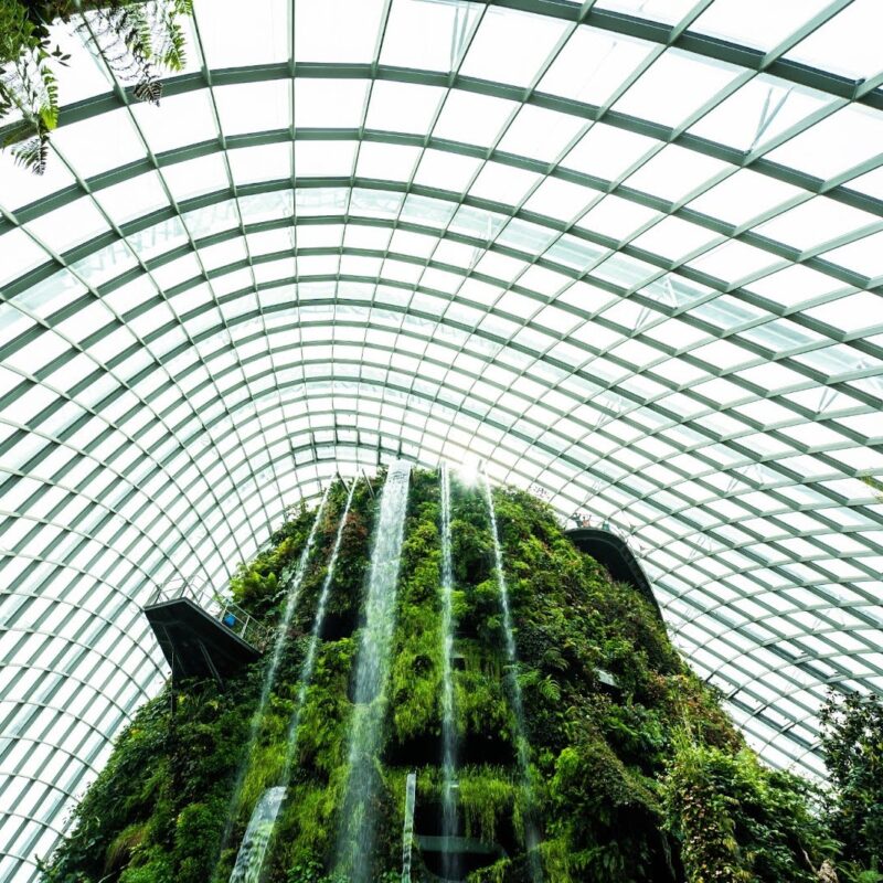 Glass-domed metal building with indoor waterfall garden