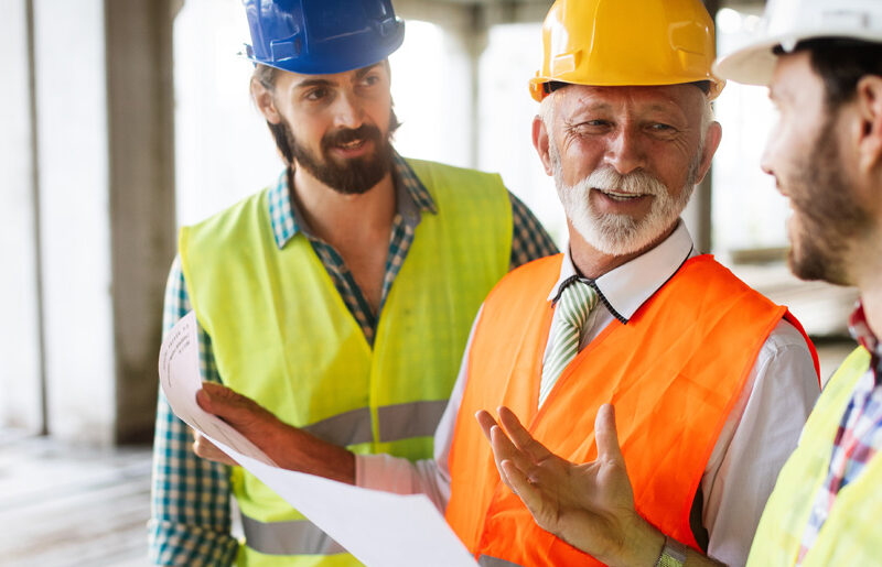 Construction team discussing a steel building interior