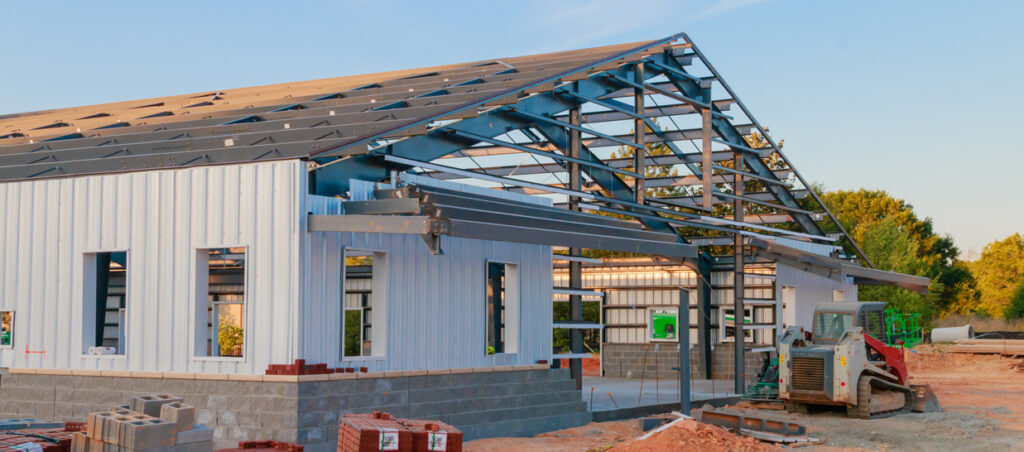 Steel building under construction with exposed roof framing