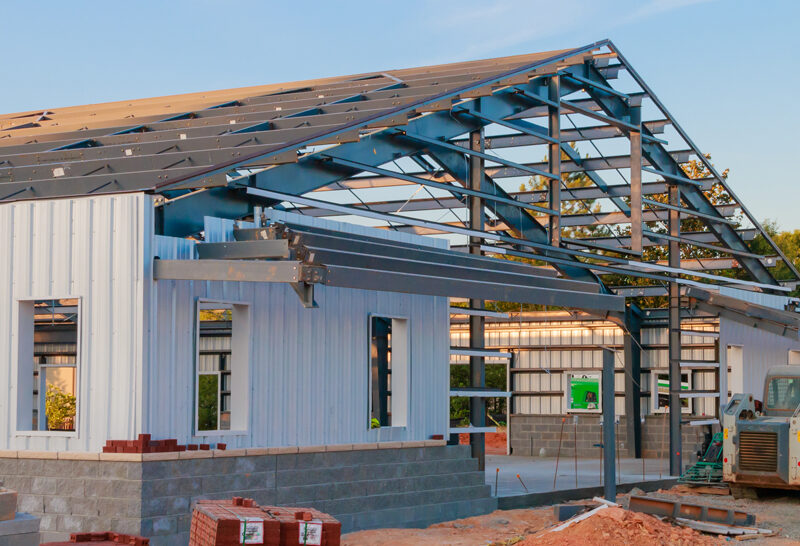 Steel building under construction with exposed roof framing