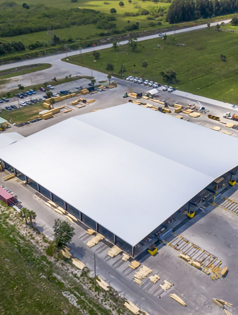 Aerial view of large white steel building under construction