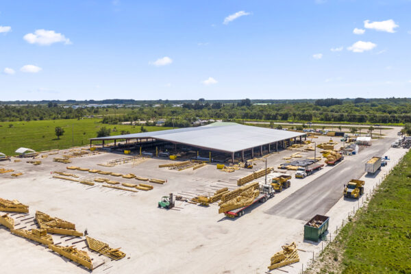 Steel building construction site with large metal roof canopy