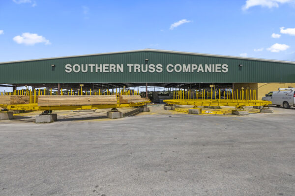 Steel truss manufacturing building exterior with storage yard