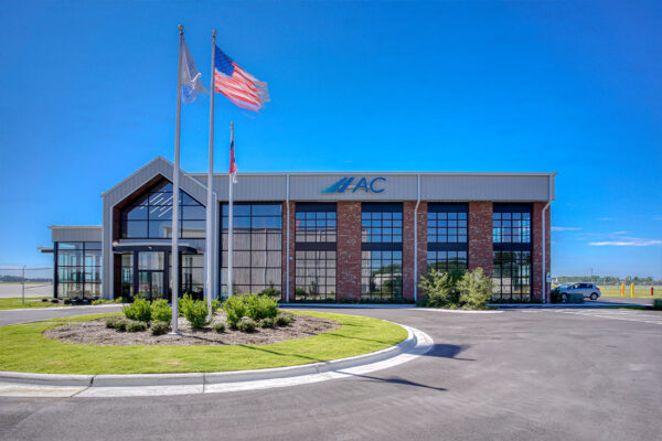 Commercial metal building with glass front and flagpoles