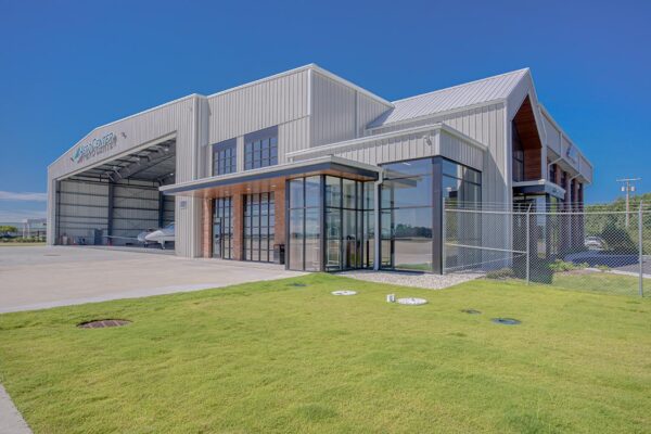 Commercial metal building with aircraft hangar and office entrance