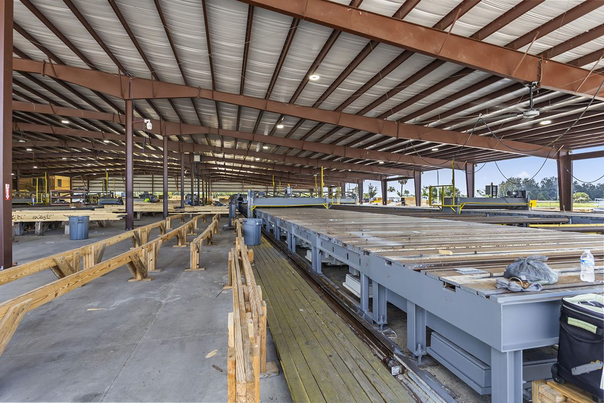 Steel horse barn interior with covered riding arena