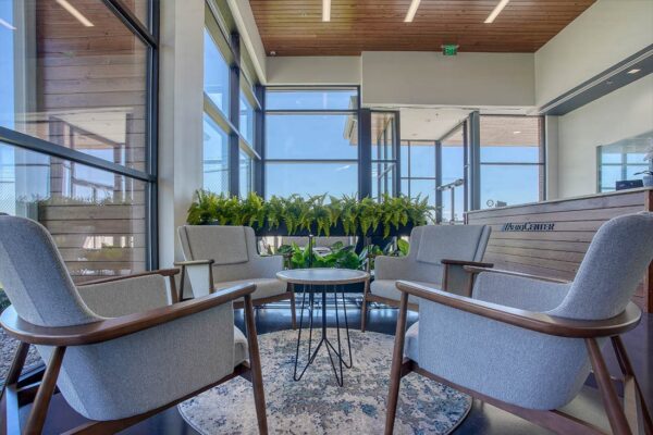 Modern aviation hangar lobby with lounge seating and large windows