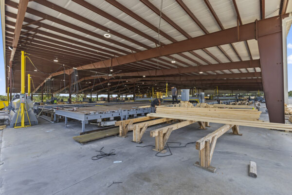 Commercial metal building construction interior with steel frame and workers