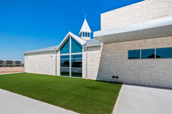 Stone-clad commercial metal building with church steeple