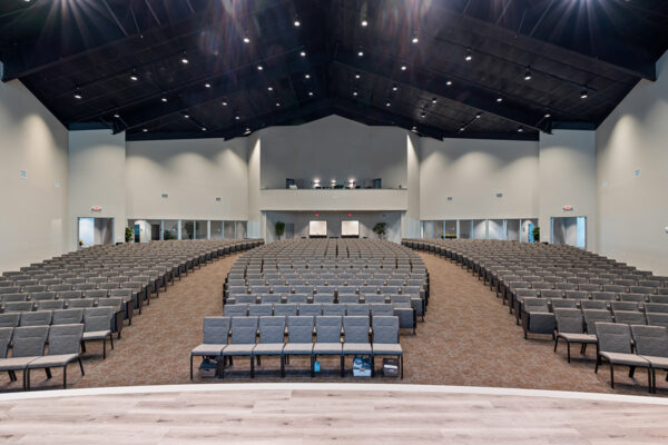 Interior of large commercial metal building auditorium with seating rows