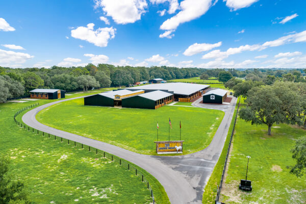 Aerial view of a steel riding arena designed for year-round riding