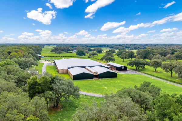 Aerial perspective of an equestrian metal building used for riding and training