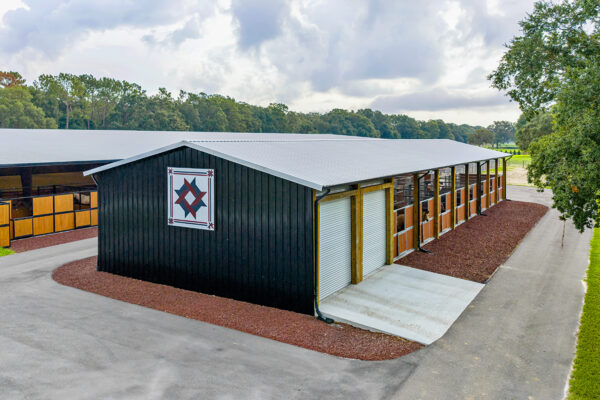 Exterior view of a steel horse arena built for roping and riding