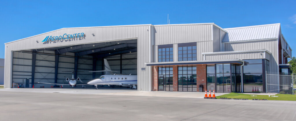 Aircraft hangar with planes inside and office entrance
