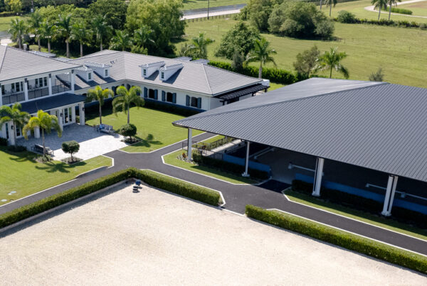 Aerial view of luxury estate with steel horse barn and arena
