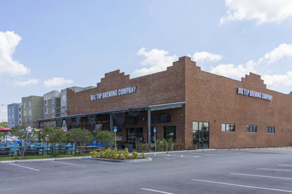 Exterior view of metal commercial building with masonry facade