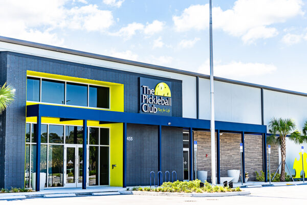 Front entrance of a metal recreational building for indoor pickleball