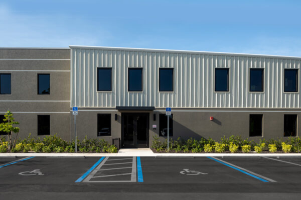 Modern commercial metal building exterior with accessible parking