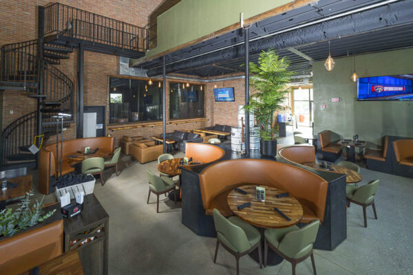Interior taproom inside metal commercial building with open seating
