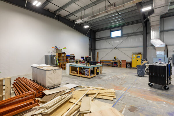 Interior of a steel metal building workshop with materials and tools