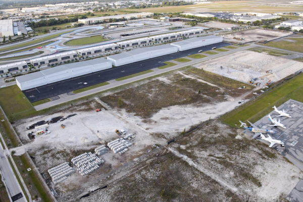 Aerial view of commercial metal buildings and aircraft hangar construction site