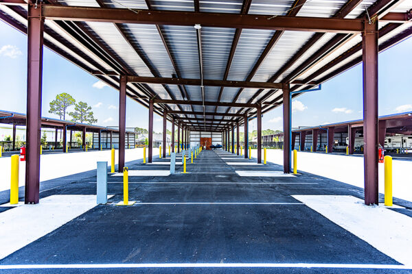 Steel covered parking structure at commercial metal building site