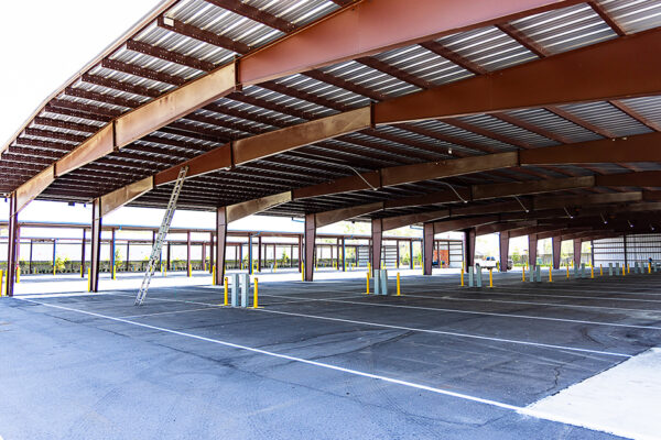Steel commercial metal building under construction with parking area