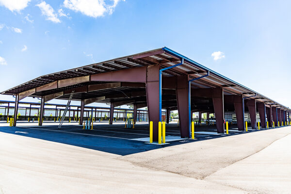 Steel commercial metal building with open covered parking bays